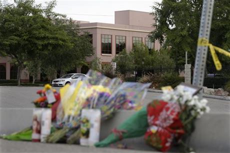 Flowers are placed near the building top center where Wednesday's shooting rampage took place at the Inland Regional Center Sunday Dec. 6 2015 in San Bernardino Calif. The FBI said it's investigating the massacre in San Bernardino Califo