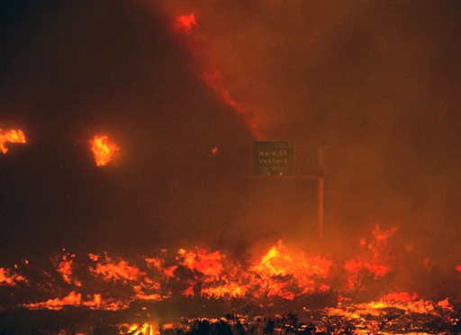 Topete fire overruns the state Highway 101 near Ventura Calif. Saturday Dec. 26 2015. The wind-whipped wildfire closed a major coastal highway in Southern California and forced dozens of homes to be evacuated authorit