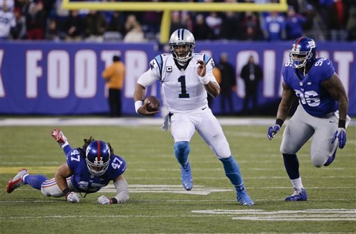 Carolina Panthers Cam Newton runs away from New York Giants Jay Bromley and Uani Unga during the second half of an NFL football game Sunday Dec. 20 2015 in East Rutherford N.J. The Panthers won 38-35