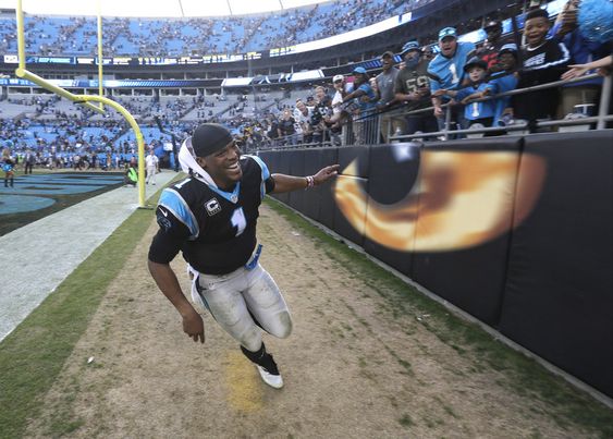 Newton celebrates with fans after an NFL football game against the Atlanta Falcons in Charlotte N.C. Sunday Dec. 13 2015. The Panthers won 38-0