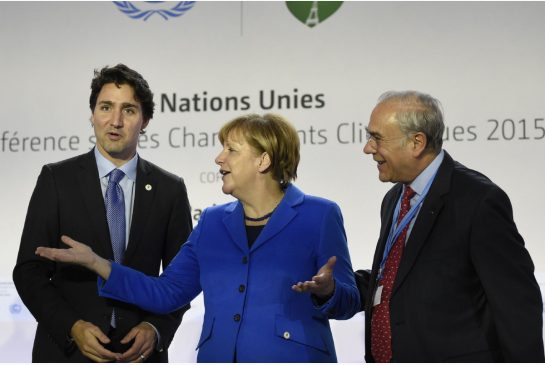 Prime Minister Justin Trudeau chats with German Chancellor Angela Merkel and OECD president Angel Gurria at climate change conference in Paris Monday