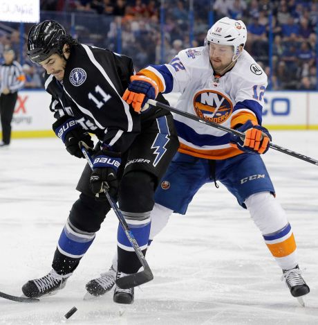 Tampa Bay Lightning center Brian Boyle is hit by New York Islanders left wing Josh Bailey as he goes after the puck during the second period of an NHL hockey game Saturday Nov. 28 2015 in Tampa Fla