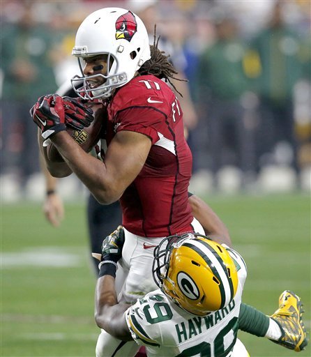 Arizona Cardinals wide receiver Larry Fitzgerald makes a catch as Green Bay Packers cornerback Casey Hayward defends during the second half of an NFL football game Sunday Dec. 27 2015 in Glendale Ariz