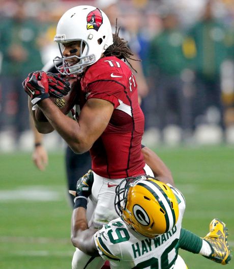 Arizona Cardinals wide receiver Larry Fitzgerald makes a catch as Green Bay Packers cornerback Casey Hayward defends during the second half of an NFL football game Sunday Dec. 27 2015 in Glendale Ariz