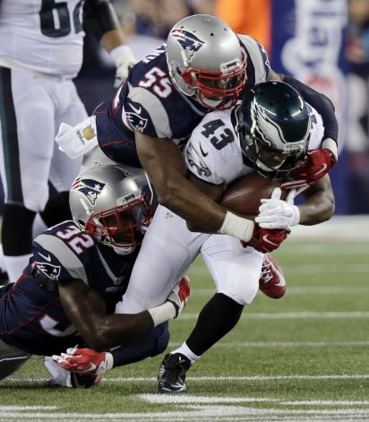 New England Patriots safety Devin Mc Courty and linebacker Jonathan Freeny tackle Philadelphia Eagles running back Darren Sproles during the first half of an NFL football game Sunday Dec. 6 2015 in Foxborough Mass