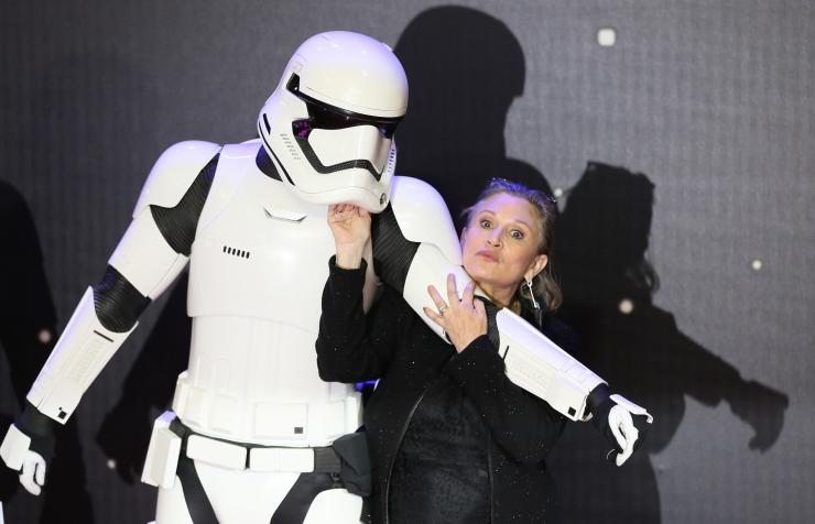 Carrie Fisher poses for cameras as she arrives at the European Premiere of Star Wars The Force Awakens in Leicester Square London