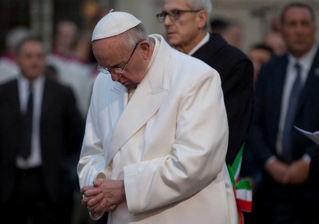 Pope Francis prays in front of the statue of the Virgin Mary on the occasion of the Immaculate Conception's feast in Rome Tuesday Dec. 8 2015. Pope Francis opened the great bronze doors of St. Peter's Basilica on Tuesday to launch his Holy Year of Me