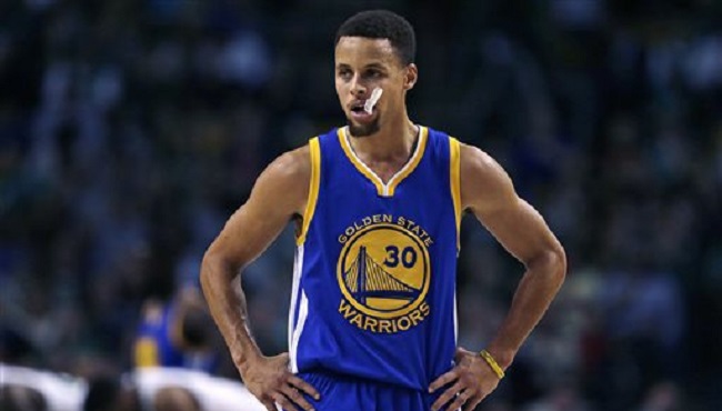 Golden State Warriors guard Stephen Curry waits for play to resume during the first quarter of an NBA basketball game against the Boston Celtics in Boston Friday Dec. 11 2015