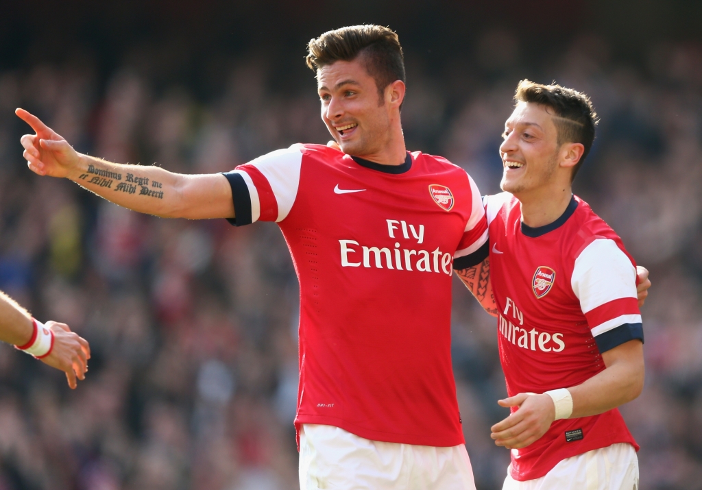 LONDON ENGLAND- MARCH 08 Olivier Giroud of Arsenal celebrates with teammate Mesut Oezil after scoring his team's fourth goal during the FA Cup Quarter Final match between Arsenal and Everton at Emirates Stadium