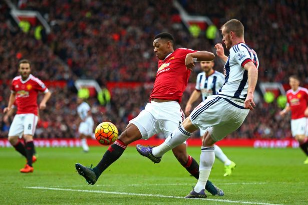 Chris Brunt of West Bromwich Albion and Anthony Martial of Manchester United