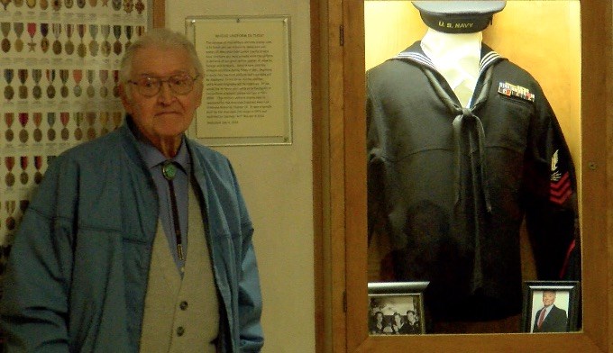 Charlie Dowd 92 of Anaconda poses next to his Navy uniform