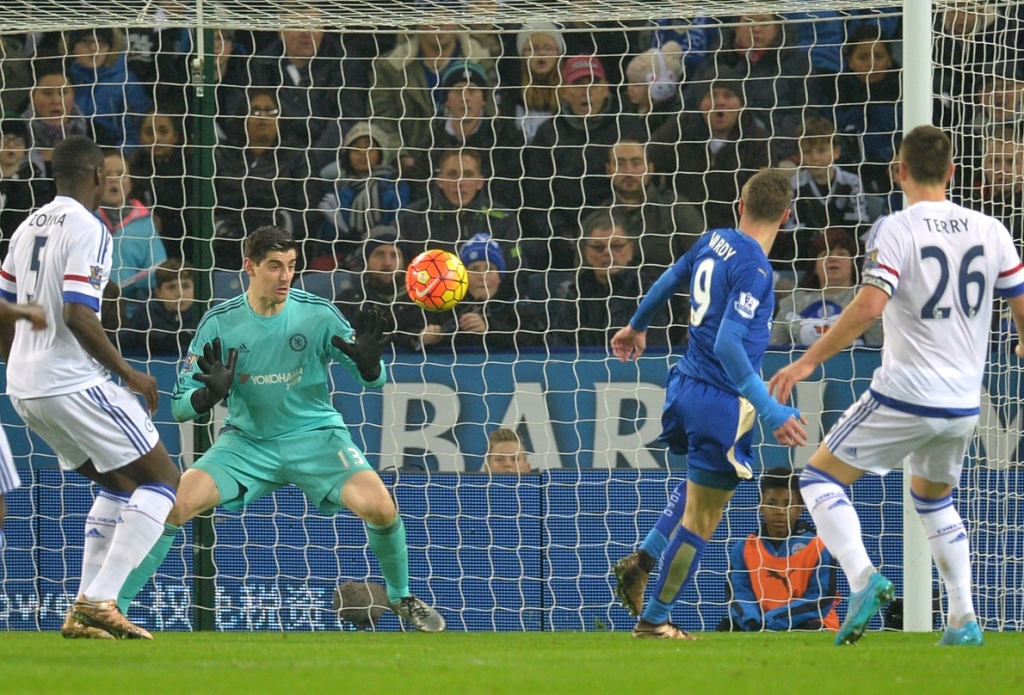 Leicester City's striker Jamie Vardy scores past Chelsea's goalkeeper Thibaut Courtois during the English Premier League match between Leicester City and Chelsea at the King Power Stadium in Leicester central England