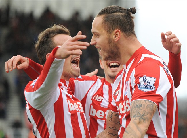 Stoke’s Marko Arnautovic right celebrates with teamates after scoring his second goal against Manchester City during the English Premier League soccer match between Stoke City and Manchester City at the Britannia Stadium Stoke on Trent England Satu