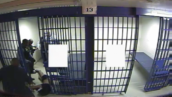 Chicago Police officers drag Philip Coleman out of his cell after apparently using a Taser on him. | Screengrab from CPD video