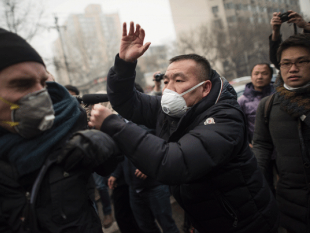 Chinese police push away journalists and supporters of human rights lawyer Pu Zhiqiang demonstrating near the Beijing Second Intermediate People's Court in Beijing