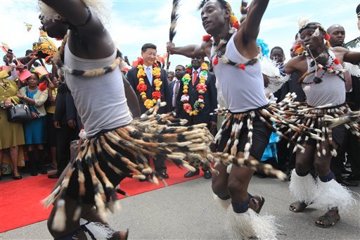 Chinese President Xi Jinping centre and Zimbabwean President Robert Mugabe centre right watch a performance by Zimbabwean traditional dancers upon his arrival in Harare Zimbabwe Tuesday Dec. 1. 2015. Jinping is in Zimbabwe for a two day State visi