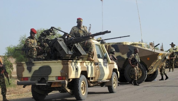 A convoy of Cameroon soldiers passes through the northern town of Dabanga as part of a raid against Nigerian Islamist group Boko Haram Jun. 2014