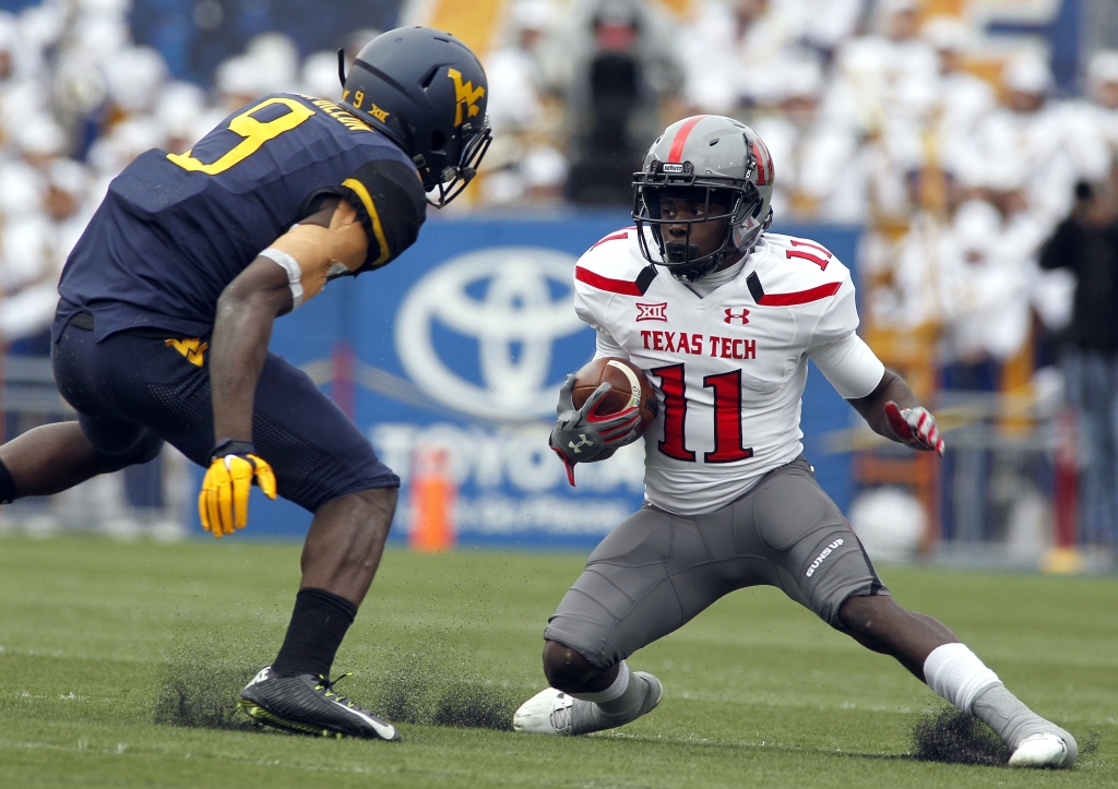 MORGANTOWN WV- NOVEMBER 07 Jakeem Grant #11 of the Texas Tech Red Raiders runs after the catch against KJ Dillon #9 of the West Virginia Mountaineers in the first half during the game