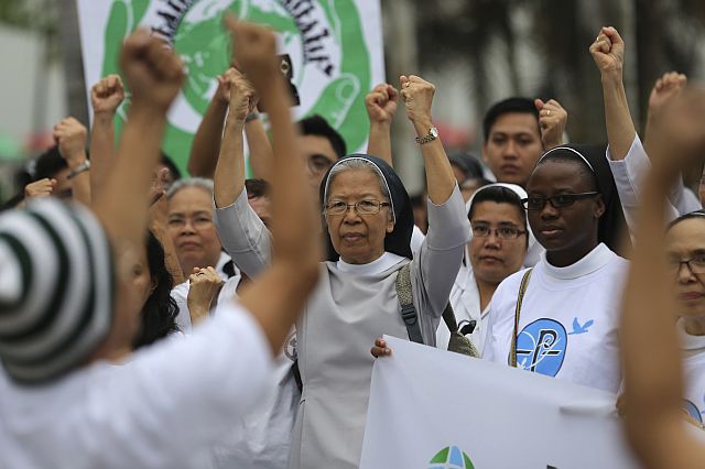 Filipinos including Catholic nuns join the Climate Solidarity Prayer March which urges decisive actions from world leaders attending the Paris Climate Change conference