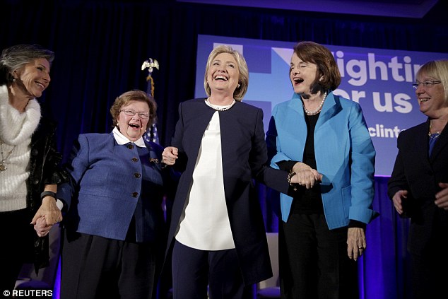 Smiling The former First Lady held the hands of California Senator Barbara Boxer Maryland Senator Barbara Mikulski Dianne Feinstein from California and Washington state's Senator Patty Murray