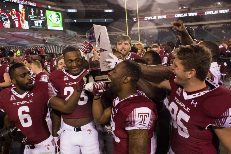 The football team celebrates with the American Athletic Conference’s East Division trophy after defeating Connecticut 27-3 Saturday. | Daniel Rainville TTN