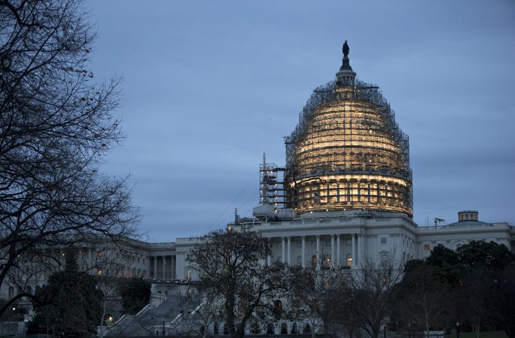 The Capitol Dome is illuminated amid scaffolding for repairs in Washington Friday morning Dec. 18 2015. The House and Senate race to wrap up votes on a massive spending and tax package which President Barack Obama promises to sign. [J. Scott Applewhi