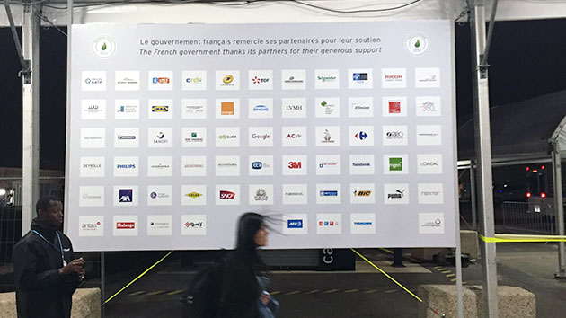 Corporate sponsorship logos at the entrance to the Paris climate summit. Courtesy Jesse Bragg