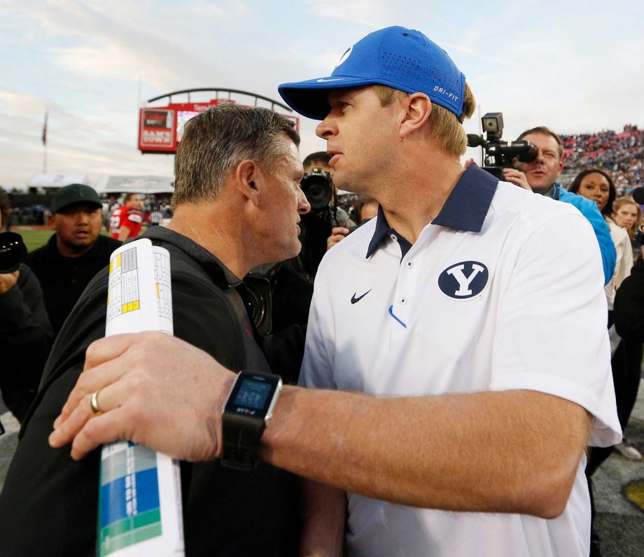 BYU head coach Bronco Mendenhall right embraces Utah head coach Kyle Whittingham after the Las Vegas Bowl NCAA college football game Saturday Dec. 19 2015 in Las Vegas. Utah won 35-28