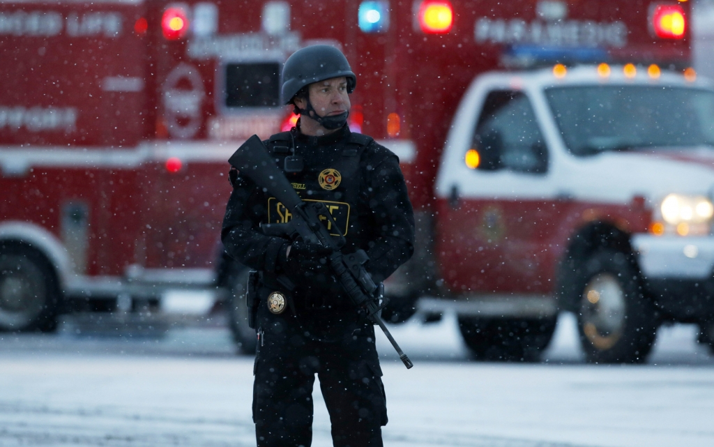 An officer stands guard near a Planned Parenthood clinic Friday Nov. 27 2015 in Colorado Springs Colo. A gunman opened fire at the clinic on Friday authorities said wounding multiple people