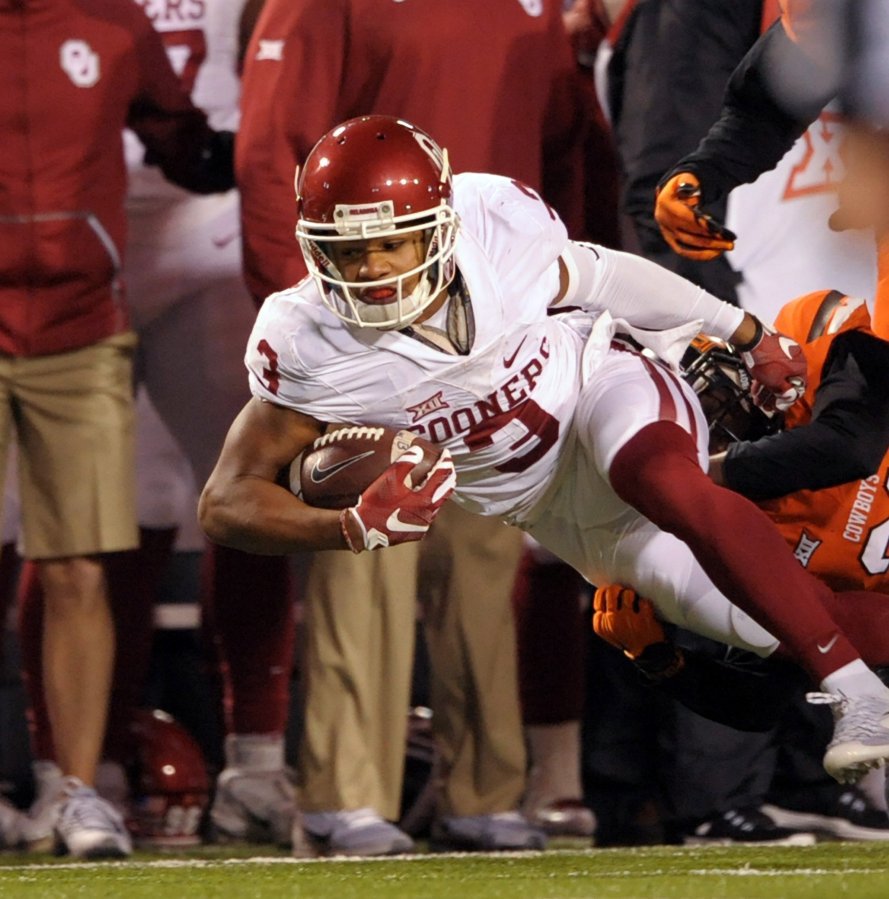 Credit Brody Schmidt           Oklahoma wide receiver Sterling Shepard leans forward for additional yards Saturday against Oklahoma State