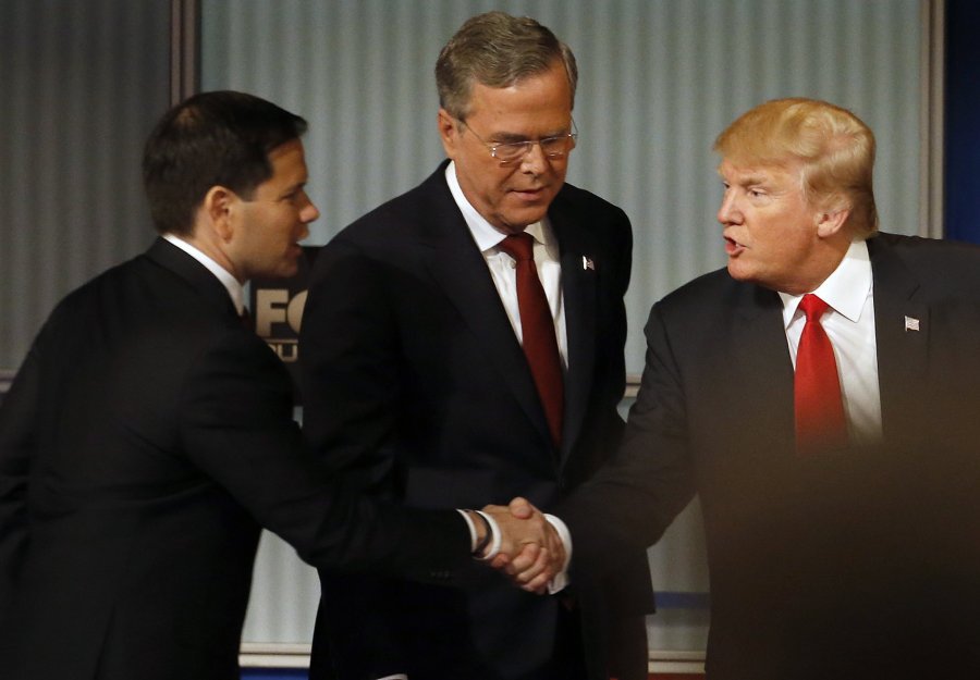 Credit Morry Gash           Marco Rubio and Donald Trump shake hands as Jeb Bush looks