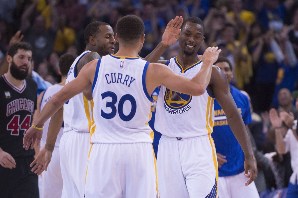 Oakland CA USA Golden State Warriors guard Andre Iguodala, guard Stephen Curry, and forward Harrison Barnes celebrate during the fourth quarter against the Chicago Bulls at Oracle Arena. The Warriors defeated the Bulls