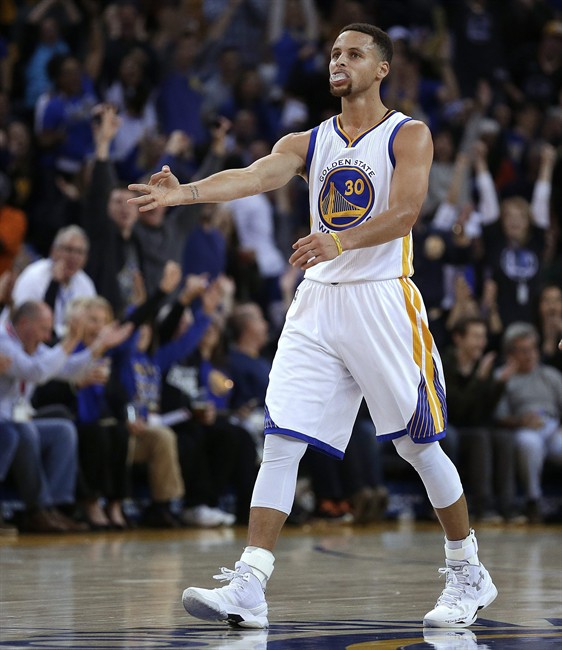 Golden State Warriors Stephen Curry celebrates a score against the Sacramento Kings during the second quarter of an NBA basketball game Monday Dec. 28 2015 in Oakland Calif