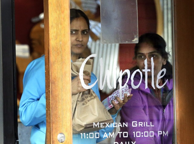 Customers leave a Chipotle restaurant with food in Portland Ore. Wednesday Nov. 11 2015