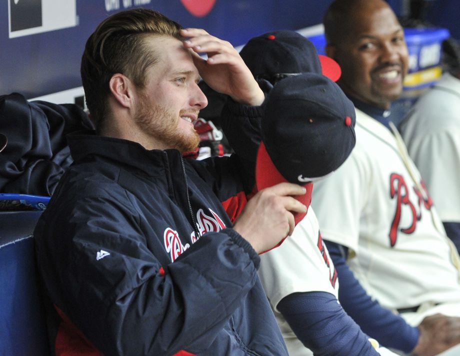 Atlanta Braves starting pitcher Shelby Miller sits in the dugout in the eighth inning of a baseball game against the St. Louis Cardinals in Atlanta. The Arizona Diamondbacks have agreed to acquire Miller