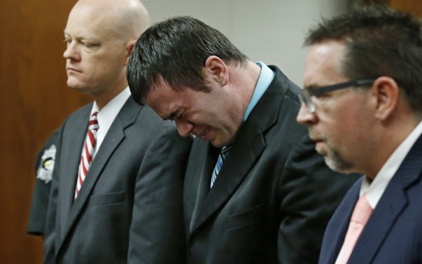 Daniel Holtzclaw center cries as he stands in front of the judge after the verdicts were read in his trial in Oklahoma City