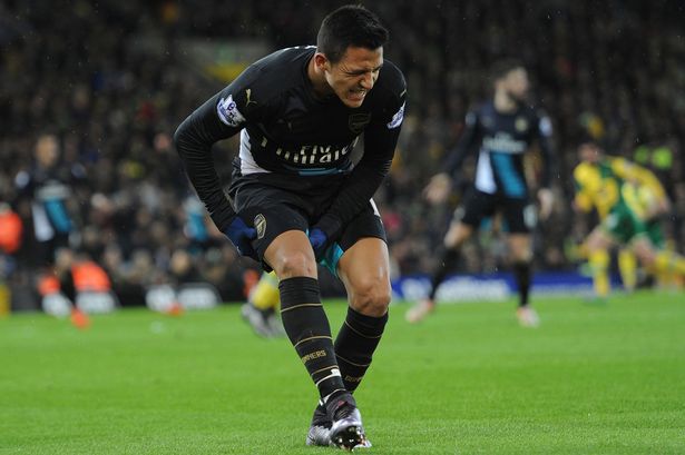 Alexis Sanchez holds his hamstring after injuring himself