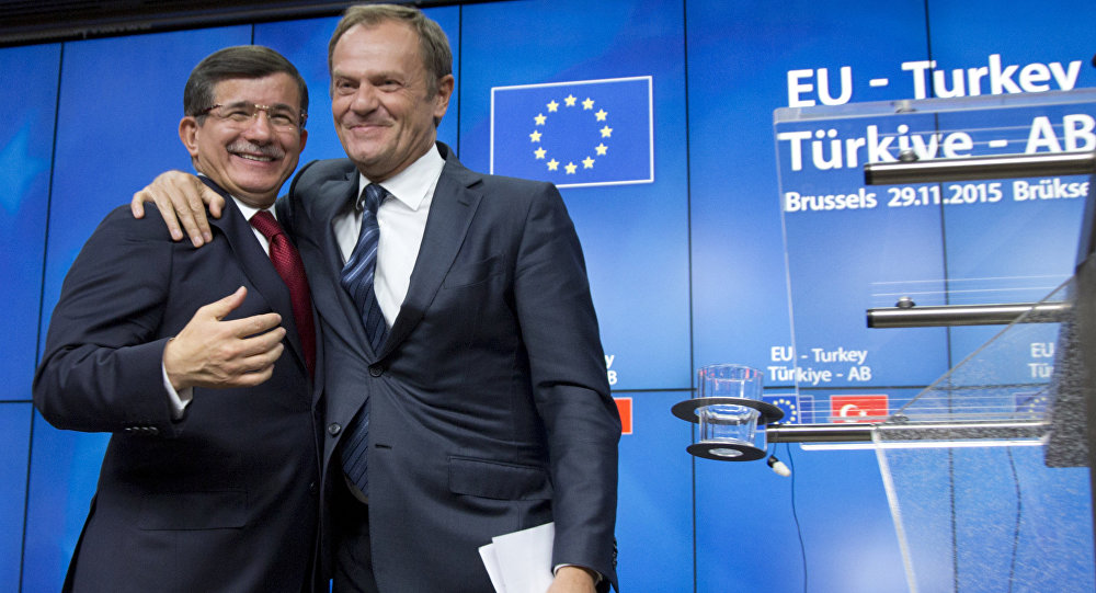 European Council President Donald Tusk right puts his arm on the shoulder of Turkish Prime Minister Ahmet Davutoglu after a media conference at an EU-Turkey summit in Brussels on Sunday Nov. 29 2015