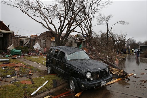 A Jeep Liberty sits destroyed on Shipman Street after Saturday's tornado in Rockwall Texas Sunday Dec. 27 2015. Tornadoes that swept through the Dallas area caused substantial damage and at least 11 people died either from the storm or related