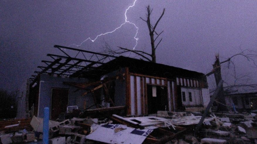 Dec. 25 2015 Lightning illuminates a house after a tornado touched down in Jefferson County Ala. damaging several houses