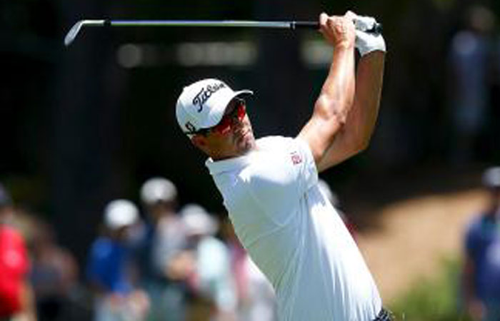 Australian golfer Adam Scott hits a shot during the first round of the Australian Open Golf Tournament in Sydney Thursday. — Reuters