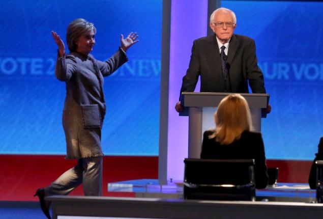 Democratic presidential candidate Hillary Clinton was late returning to the stage in Saturday night’s debate because she got held up in the bathroom line a report says