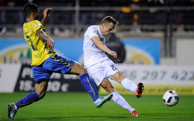 Denis Cheryshev of Real Madrid shoots past Cristian Marquez