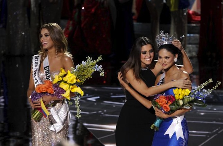 Miss Universe 2014 Paulina Vegas hugs winner Miss Philippines Pia Alonzo Wurtzbach as Miss Colombia Ariadna Gutierrez stands by during the 2015 Miss Universe Pageant in Las Vegas Nevada