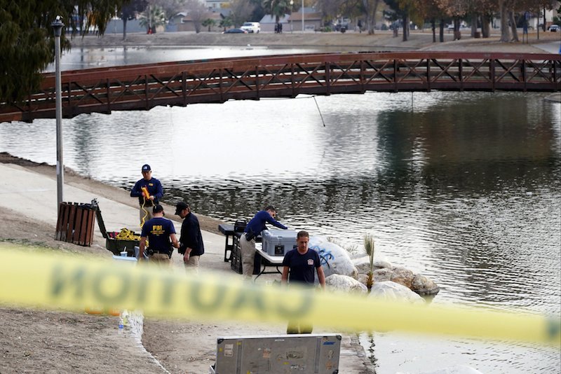 FBI agents pack up diving gear after searching in the water at Seccombe Lake Park after last week's shooting in San Bernardino California yesterday. – Reuters pic