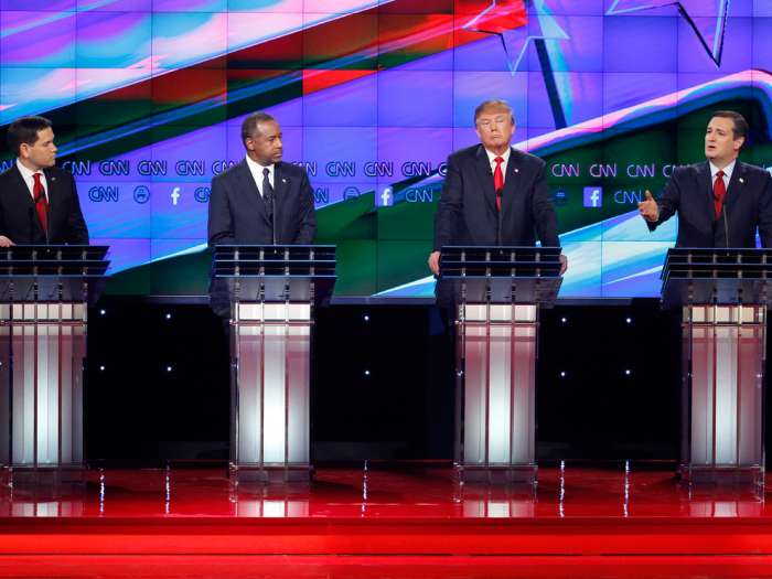 Ted Cruz right speaks during an exchange with Marco Rubio left as Ben Carson second from left and Donald Trump look on during the CNN Republican presidential debate at the Venetian Hotel & Casino on Tuesday Dec. 15 2015 in Las Vegas. (AP