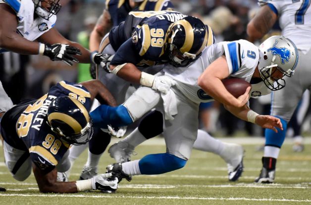 Detroit Lions quarterback Matthew Stafford right is sacked for a 7-yard loss by St. Louis Rams defensive tackle Aaron Donald as Rams defensive tackle Nick Fairley left gets in on the play during the fourth quarter of an NFL football game Sunday