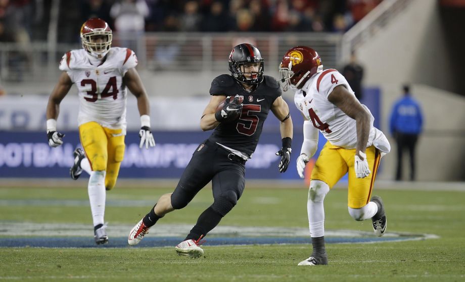 Stanford's Christian Mc Caffrey 5 on a long run third quarter is chased by USC's Peter Kalambayi 34 and Blake Martinez 4 as Stanford went on to beat on the USC Trojans 41-22 in the NCAA College PAC-12 Football Championship at Levi Stadium in Santa Clar