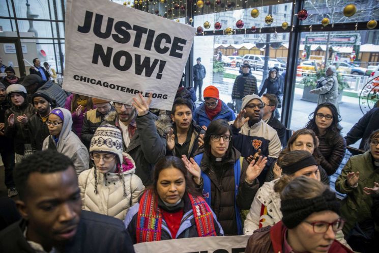 Clergy labor leaders and supporters gather at the Cook County Administration Building on Thursday in Chicago to demand the resignation of Cook County State's Attorney Anita Alvarez before delivering 32,000 petition signatures calling for her to quit. The