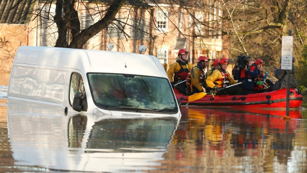 Emergency services navigate a flooded street in York